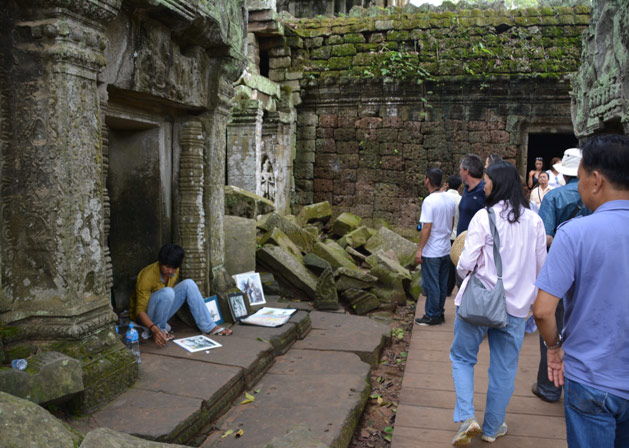 An older ODA boy paints at one of Siem Reap's ancient temples, earning money for his college education.