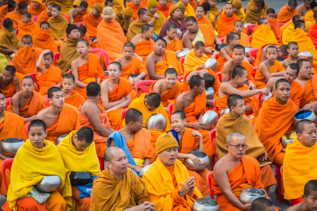 From Gianni: This was taken recently in Chiang Mai. Every year 10,000 monks from all over Thailand come to the city for a spectacular ceremony where they collect offerings from the crowd. The ceremony starts early in the morning. In this picture the monks are waiting for the ceremony to start.