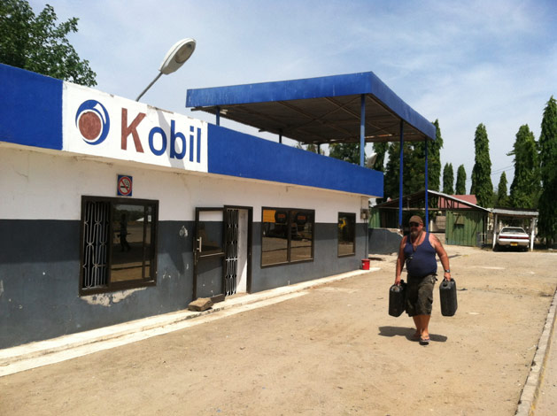 Mick fills up water jugs at a fake African Mobil station named Kobil.