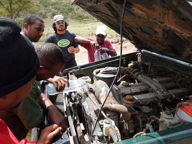 Our guide Joe speaks with our safari drivers as they try to fix our radiator.  Knowing very little about cars is another reason I'm glad we booked an overland tour instead of trying to drive ourselves.