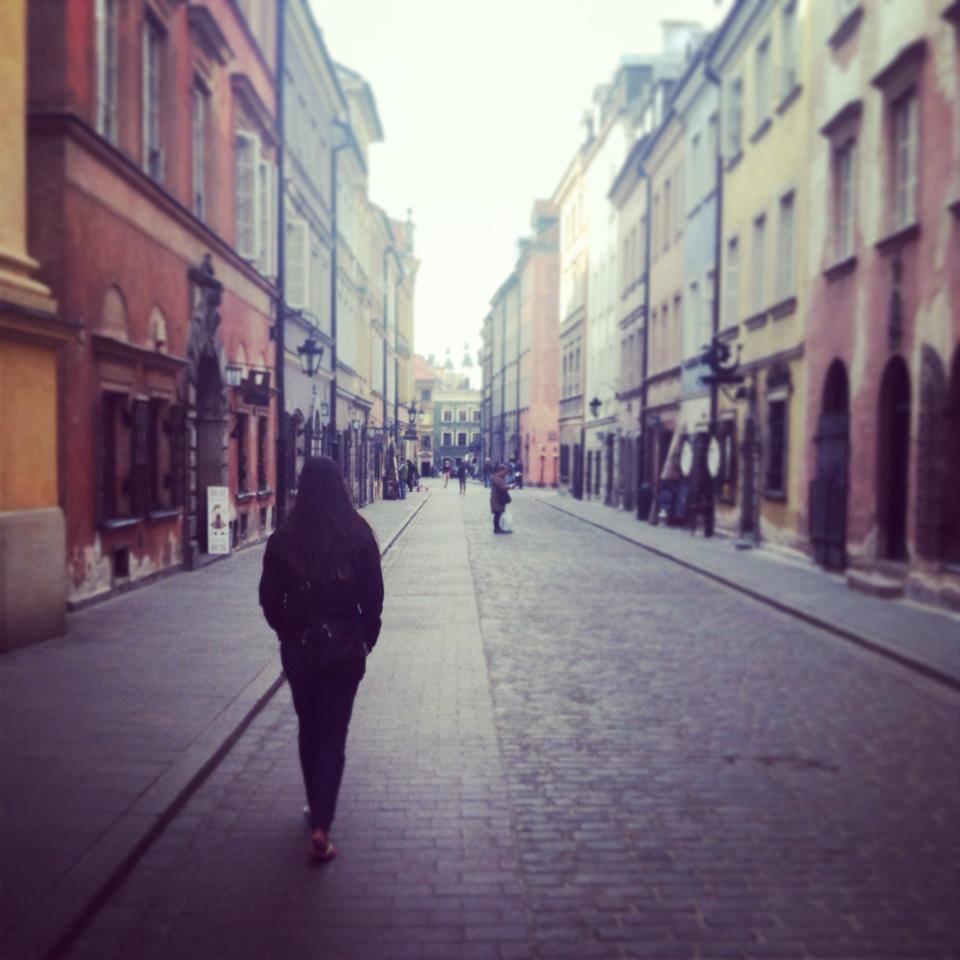 Alissa walking through Warsaw's Old Town.
